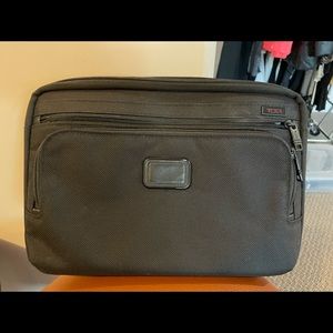 Tumi Surface tablet case. 1 pocket for the tablet & keyboard, 2 others for misc